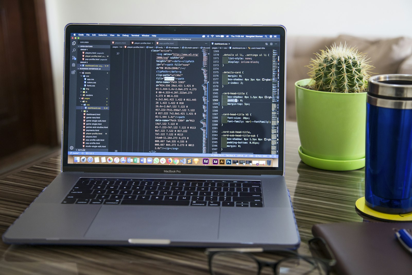 A laptop open on a wooden desk, with a website under development on the screen.